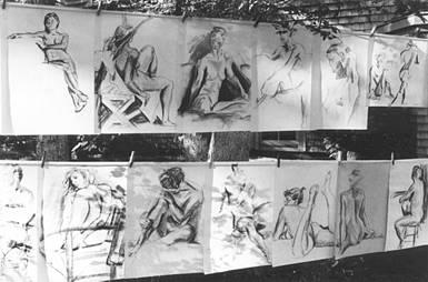 18"x24" figure drawings hanging from clotheslines outside
